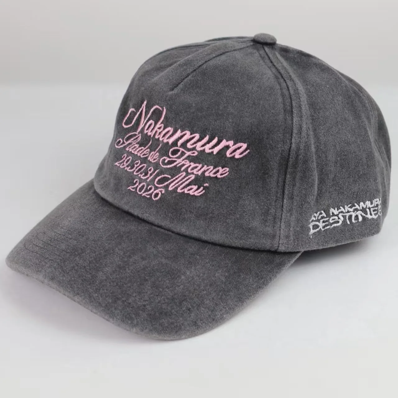 Charcoal-grey garment-washed cotton cap with pale pink embroidery photographed for BDBRIM