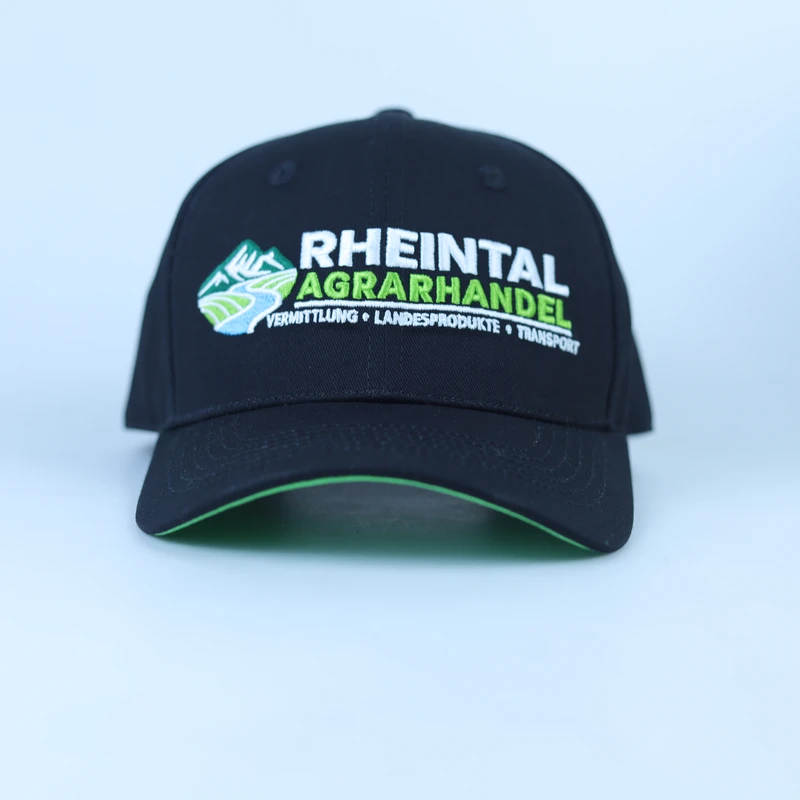 Front of black promotional cap showing white and green logo embroidery and green visor edge