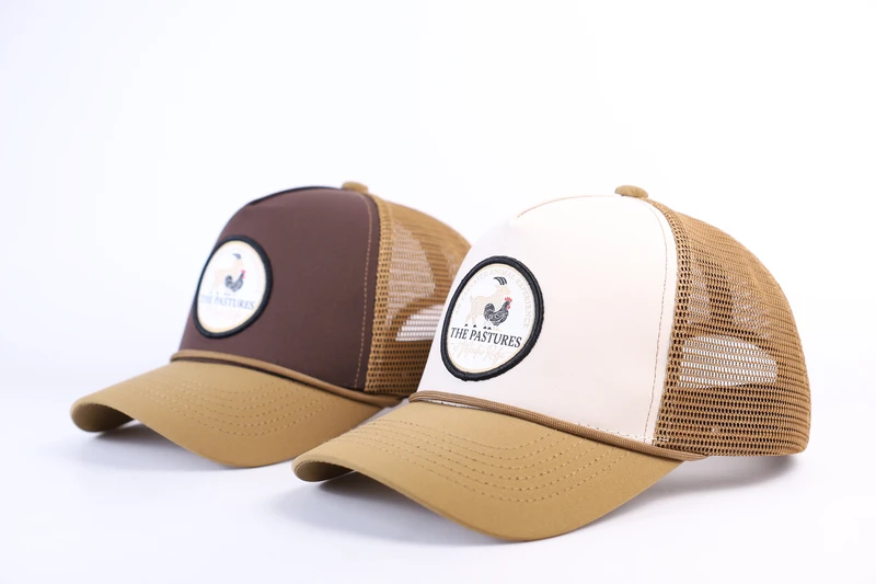 Two tan and brown rope-trim trucker cap colorways with circular front patches