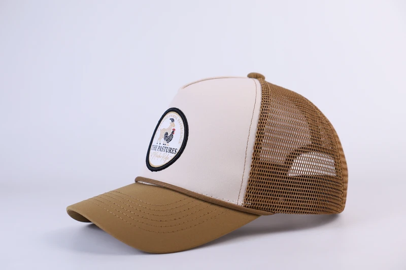 Cream front trucker cap with tan visor, tan mesh and round patch