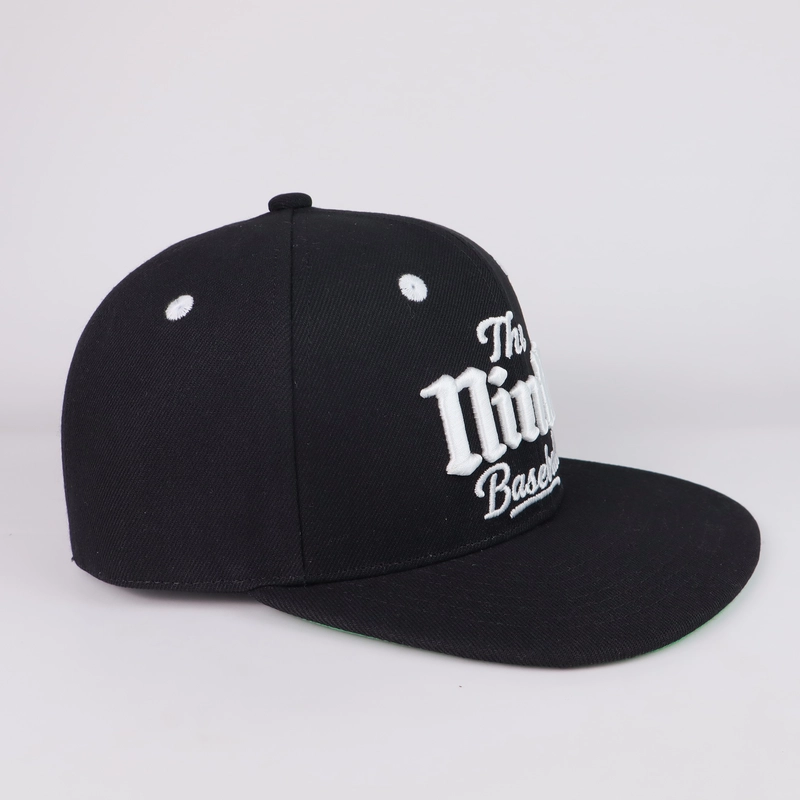Side view of black flat-brim cap with dimensional white front embroidery