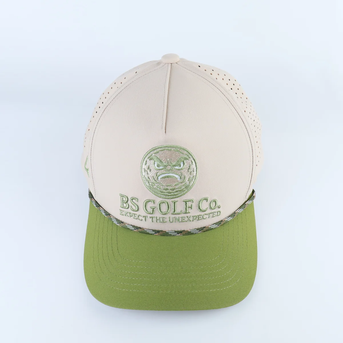 Cream and lime green golf cap with green embroidery and patterned visor rope