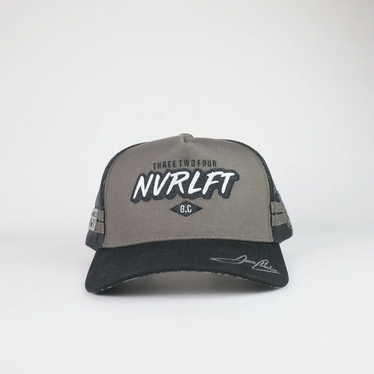 Gray and black mesh trucker cap with layered front embroidery and black curved visor