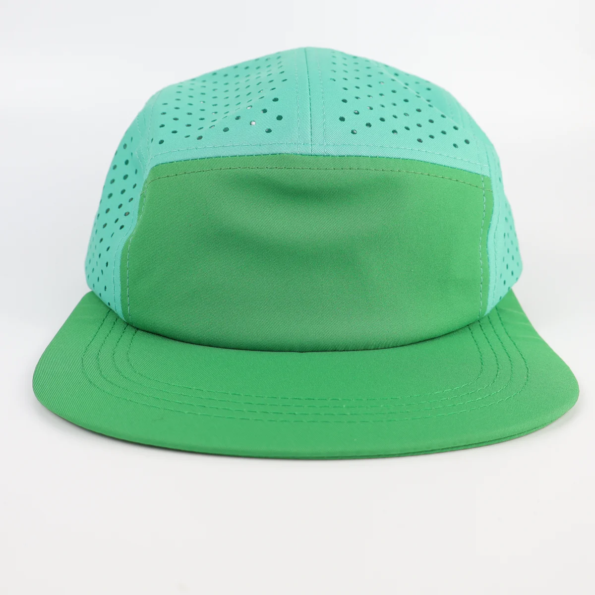 Front view of mint green five-panel cap with perforated side and crown fabric
