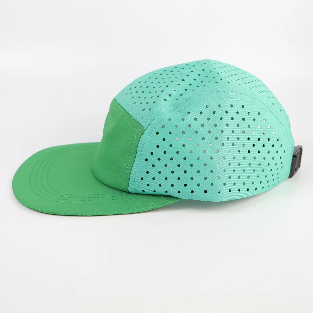 Side profile of mint five-panel cap with green front and laser perforated crown panels